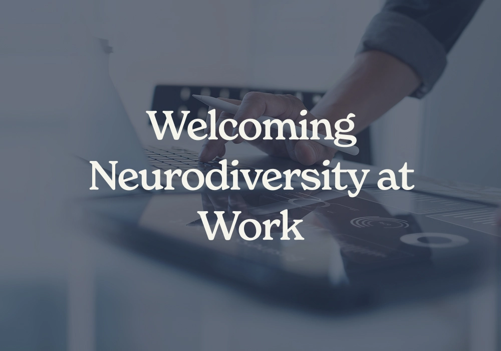 Professional using a digital tablet to review inclusive workplace and neurodiversity resources