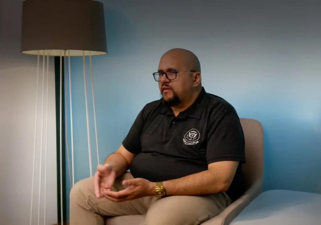 Image of Cody Hart talking in a chair